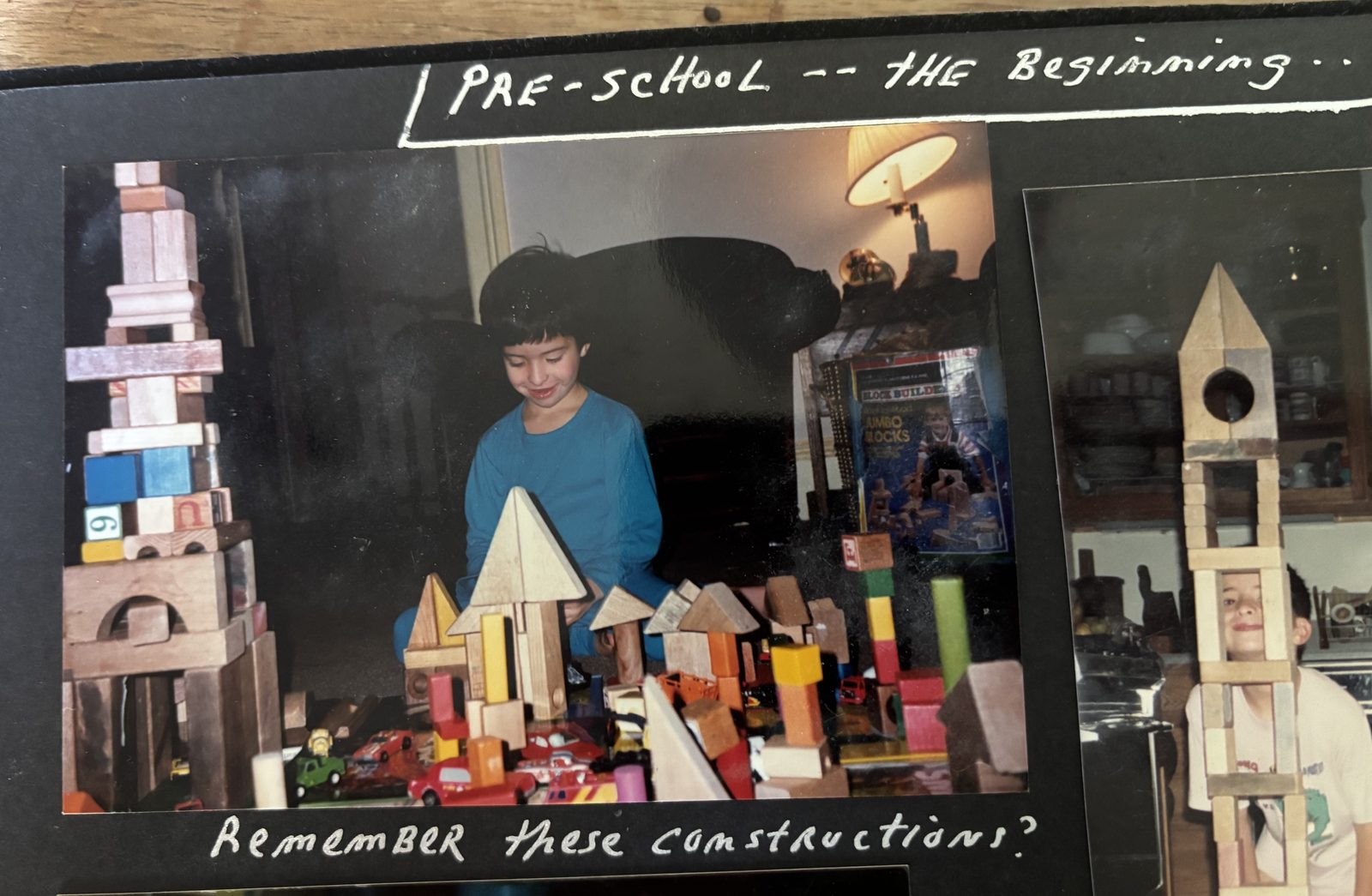 A page from my family photo album: preschool-age me surrounded by wooden block towers, hand-captioned 'Pre-school — the beginning… Remember these constructions?'